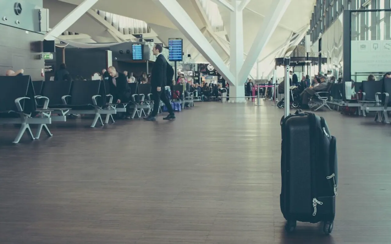 Luggage wrapping machine operating in a modern airport terminal