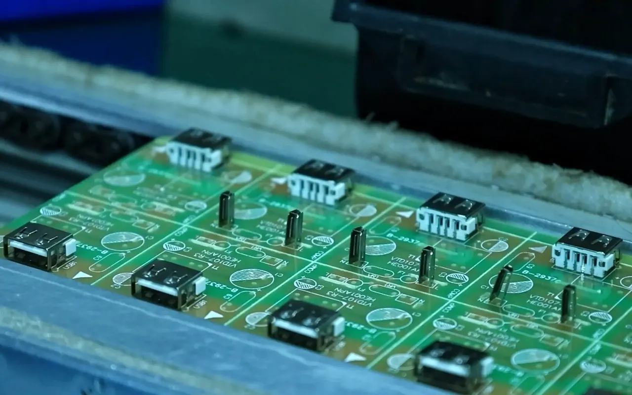 Electronics engineer inspecting a precision resistive sensor array PCB