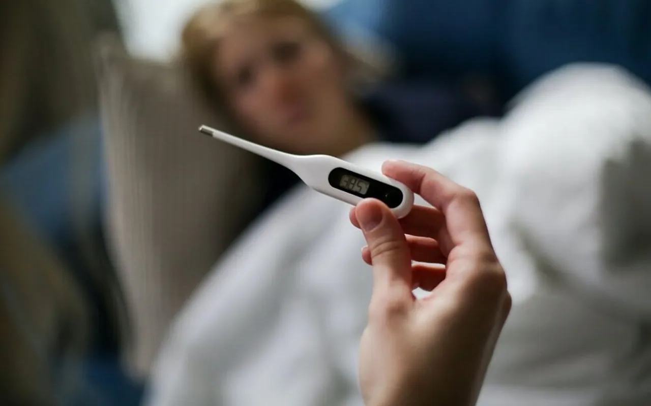 Small wearable temperature patch used with a caregiver mobile app
